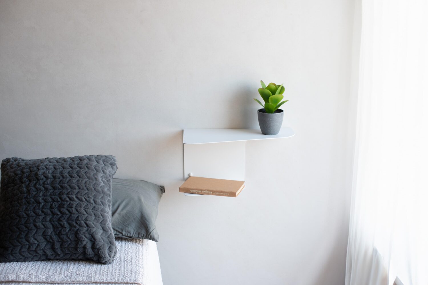 mesita de noche flotante de pared con planta y libreta